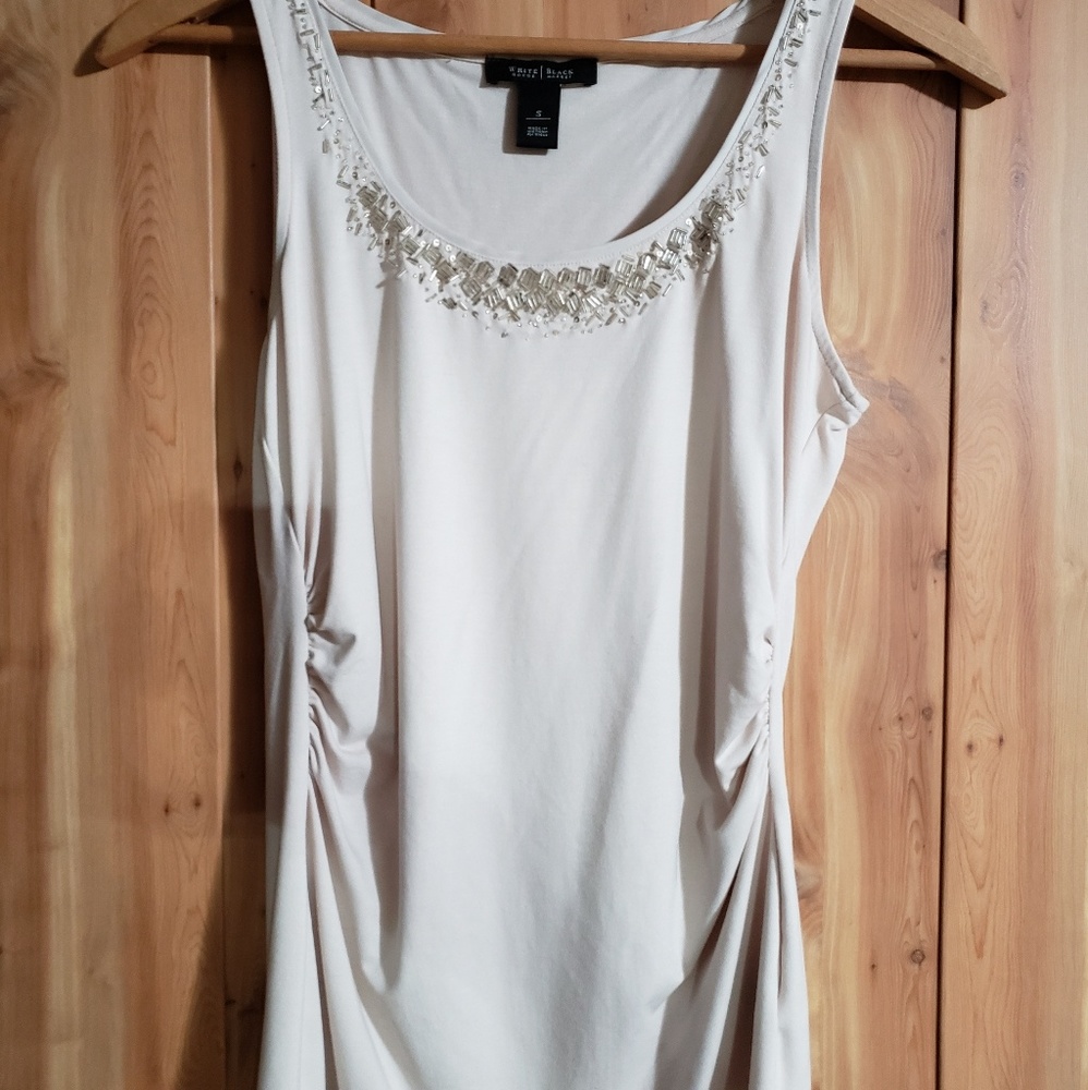 Cream colored sleeveless shirt with beaded accents